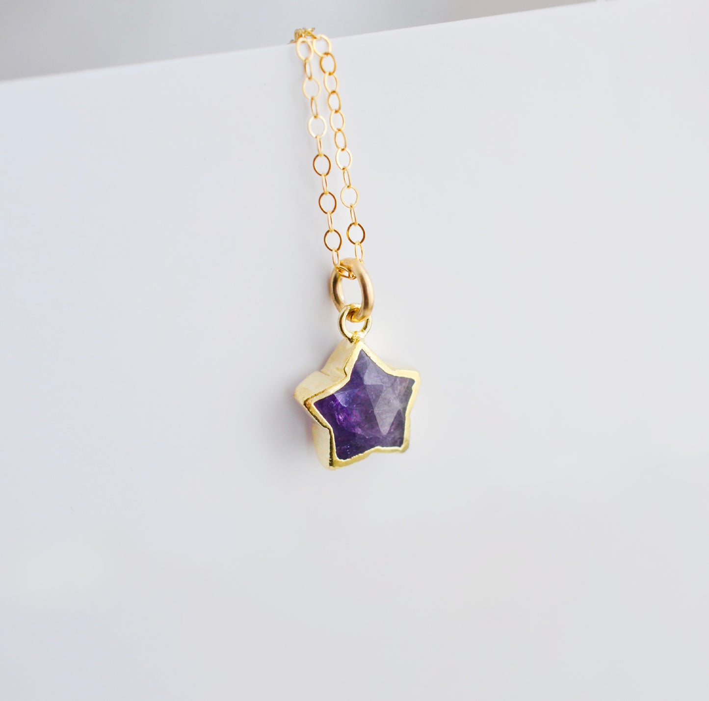 Handmade genuine purple amethyst star crystal pendant set on a 14k gold filled chain.