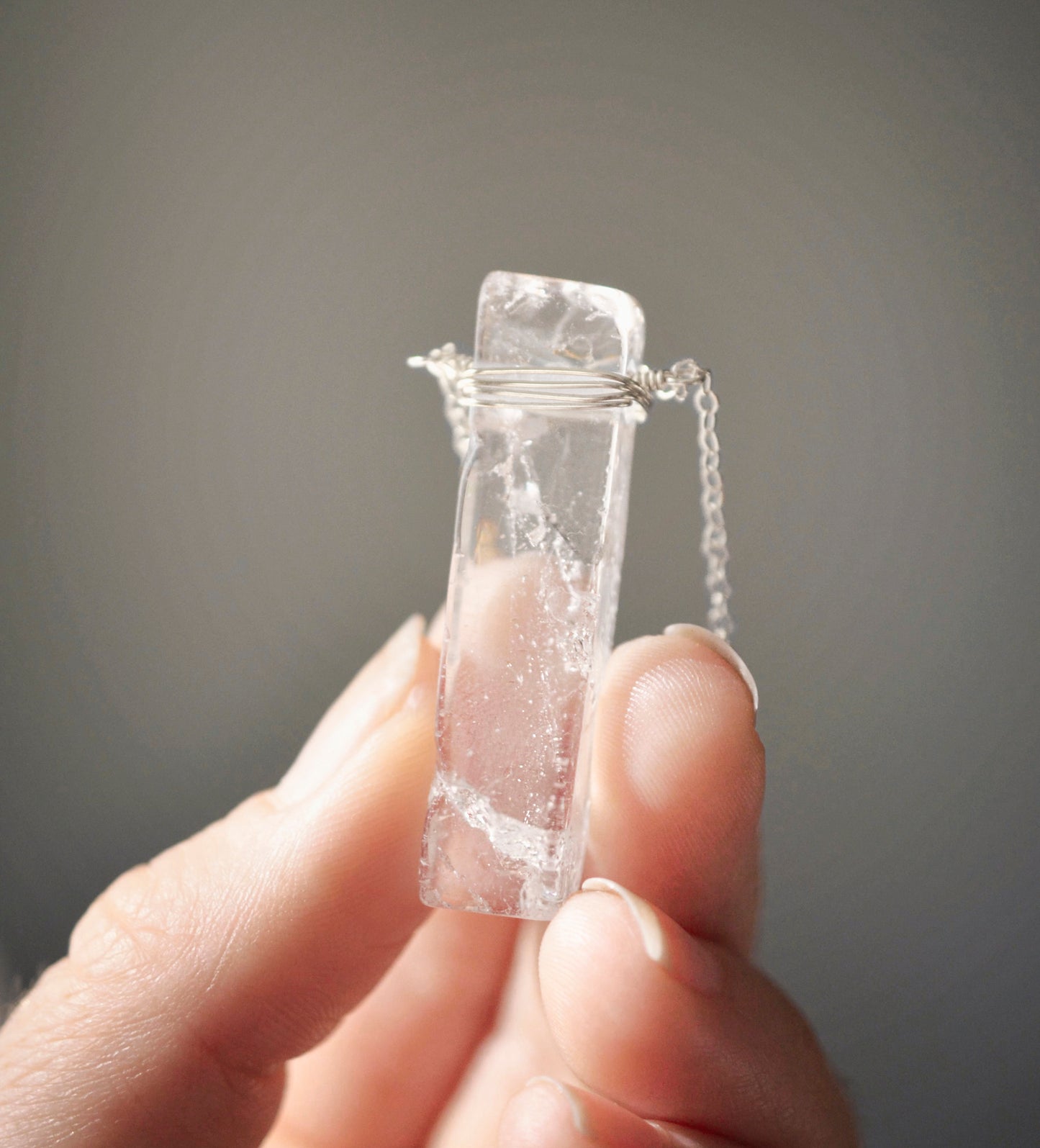 Rectangular shaped natural clear crystal Quartz gemstone set into a sterling silver chain.