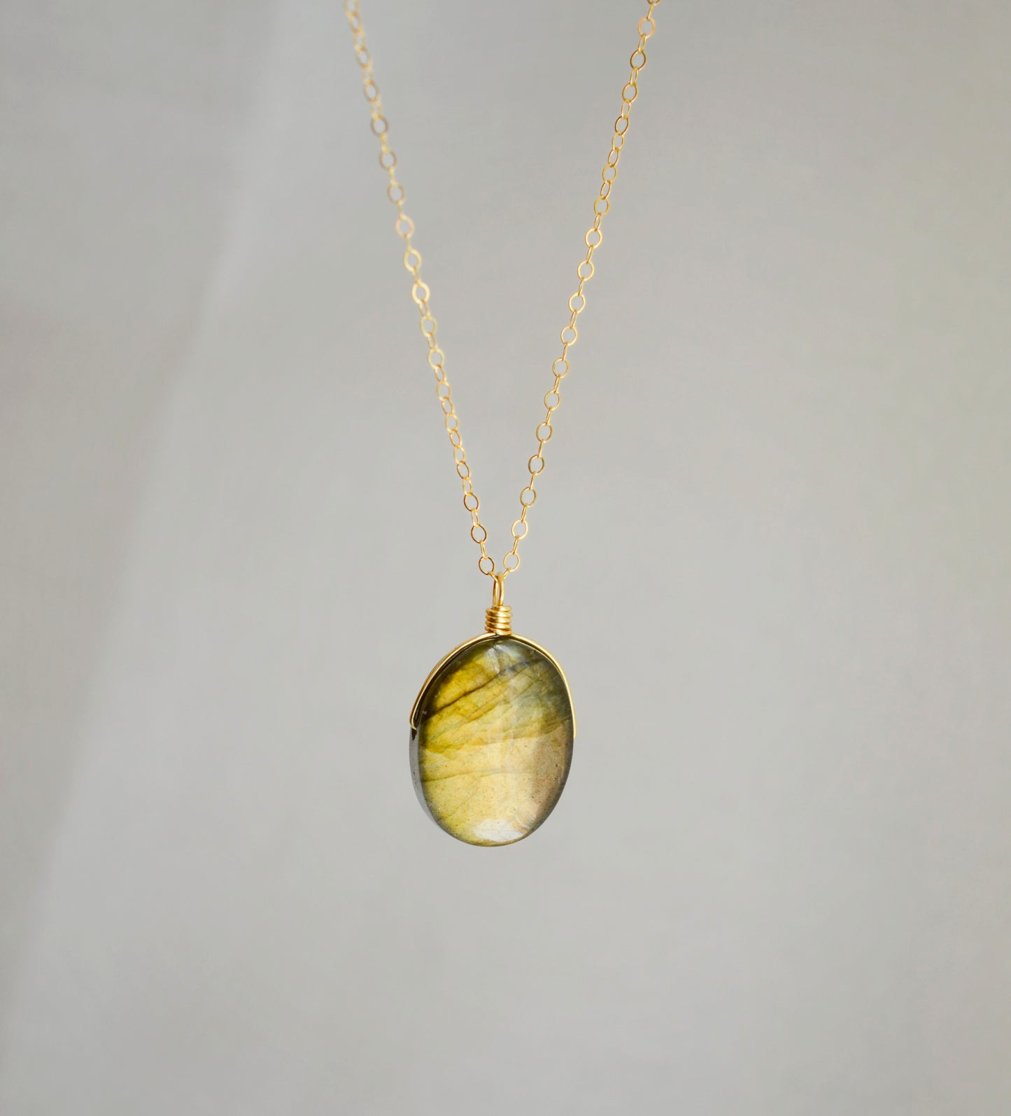 Labradorite oval pendant with yellow-green flash. The chain in 14k gold filled.