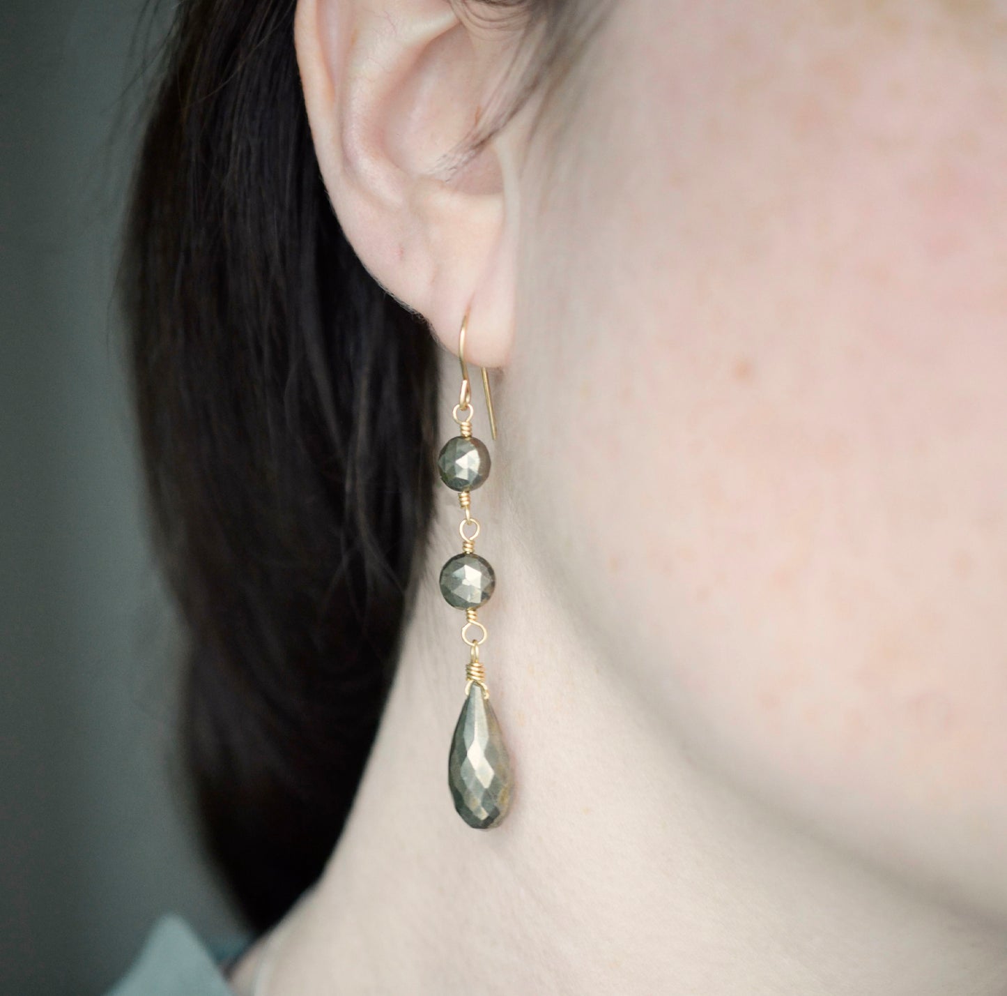 Modeled image. Long Pyrite gemstone dangle earrings worn in gold.