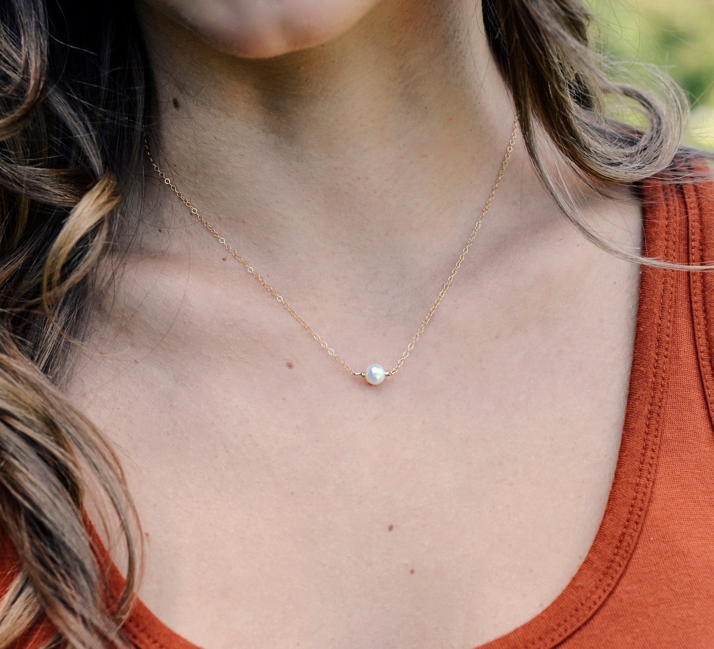 Single round white freshwater pearl necklace on a 14k gold filled chain.