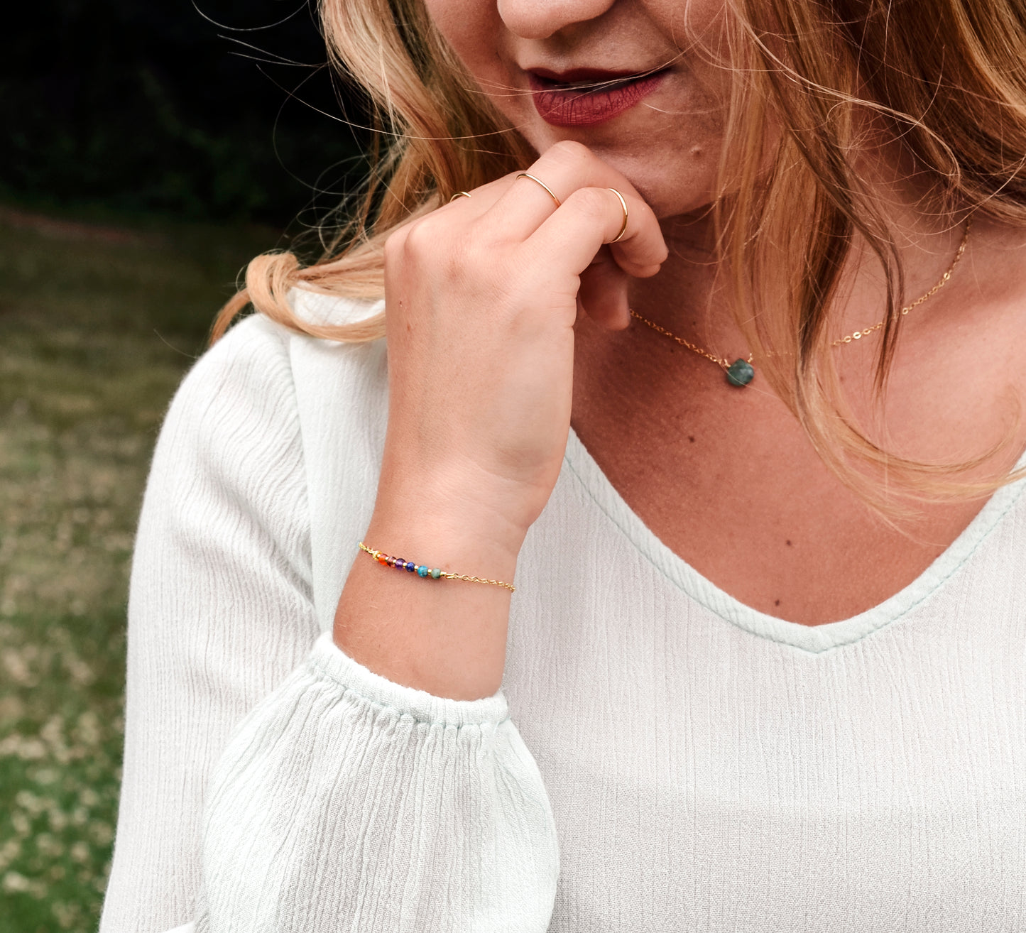 Handmade gemstone bracelet featuring CZ, garnet, amethyst, lapis lazuli, apatite, and emerald crystals arranged on a short bar. Available in gold filled or sterling silver.