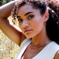 Handmade necklace featuring nine natural Carnelian gemstones set onto a gold filled chain. Sterling Silver is also available. Modeled Image.
