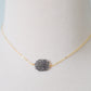 Genuine raw black sunstone gemstone set on a gold filled chain. The shape of the stone is irregular.