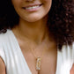 Rectangular shaped natural clear crystal Quartz gemstone set into a 14k gold filled chain. Modeled image.