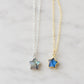 Two star-shaped natural labradorite celestial pendant necklaces on delicate chains, one in sterling silver silver and the other in 14k gold filled. Handmade jewelry in Connecticut by Gemnia.