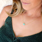 Genuine aqua blue Amazonite gemstone cut into a faceted cube and suspended on a gold filled glittering chain. Modeled Image.