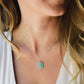 Aqua blue amazonite slice gemstone set onto a sterling silver chain. The stone is semi oval in shape, but irregular. It's smooth polished, but with raw edges. 