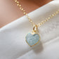 Pale blue natural aquamarine gemstone heart pendant set on a 14k gold filled chain. The stone is genuine and faceted with a 22k gold electroplate bezel.