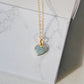 Pale blue natural aquamarine gemstone heart pendant set on a 14k gold filled chain. The stone is genuine and faceted with a 22k gold electroplate bezel.