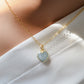 Pale blue natural aquamarine gemstone heart pendant set on a 14k gold filled chain. The stone is genuine and faceted with a 22k gold electroplate bezel.