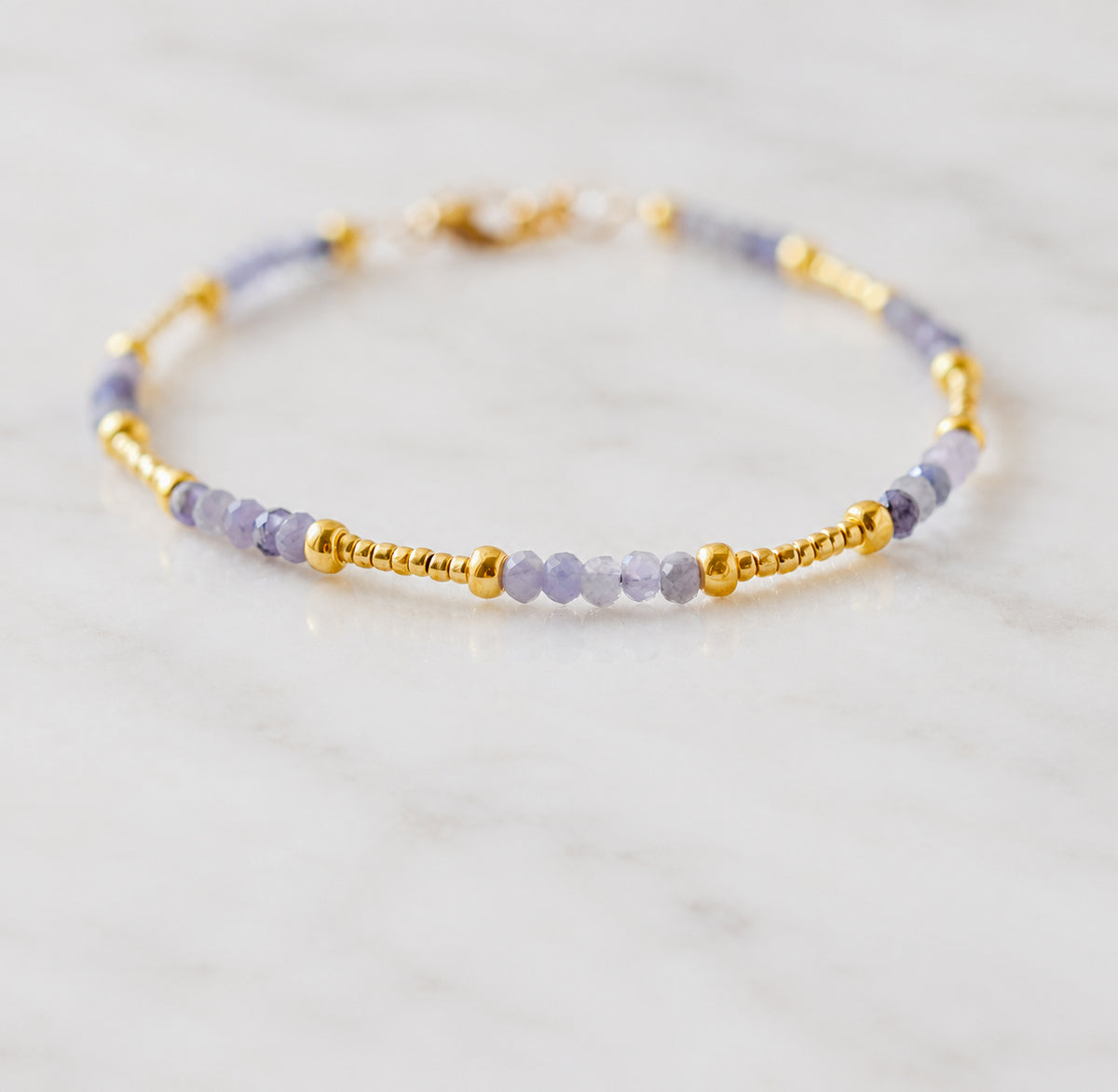 Handmade beaded gemstone natural Tanzanite crystal bracelet in gold filled or sterling silver. These bracelets feature a gemstone of your choice on a bracelet that can be stacked with others or worn alone. Handmade jewelry by Gemnia in Connecticut