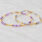 Two beaded bracelets with purple Amethyst and Tanzanite gemstone beads in gold. Handmade gemstone bracelets for layering and stacking.