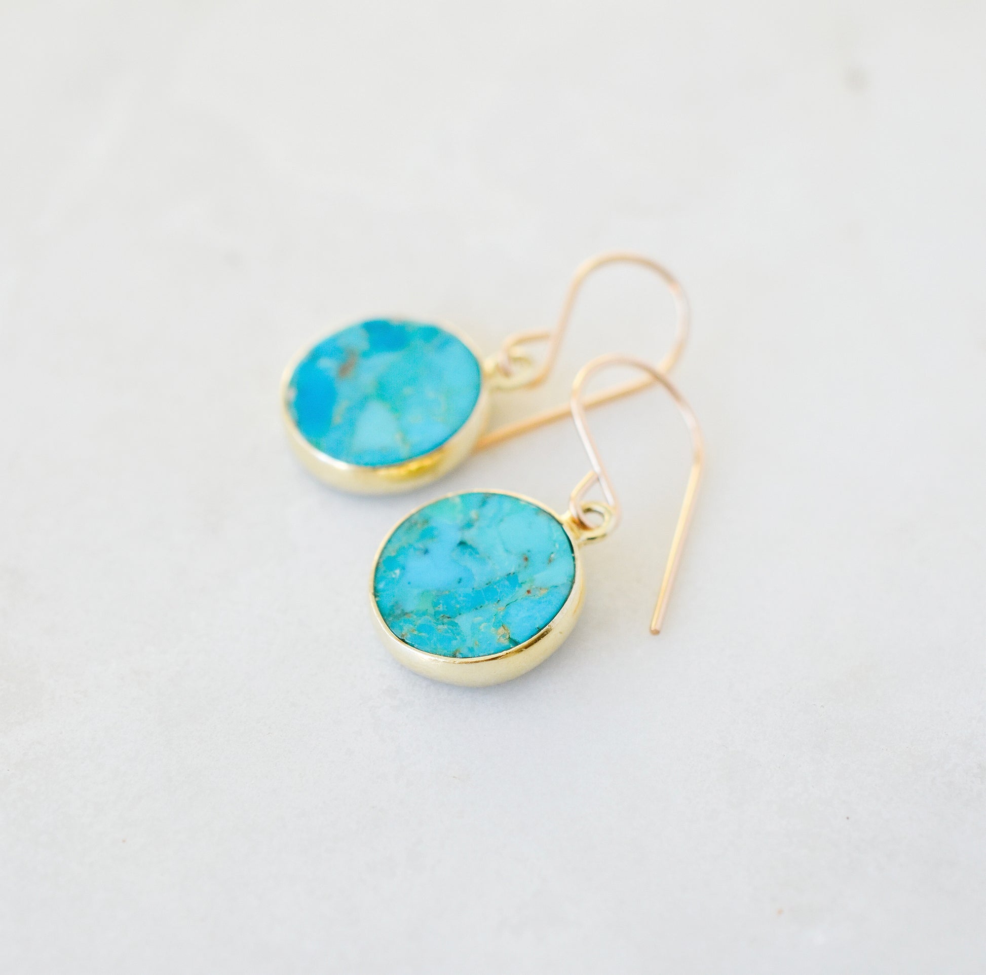 Natural round coin shaped blue turquoise earring dangles in 14k gold filled. Dainty handmade gemstone jewelry.