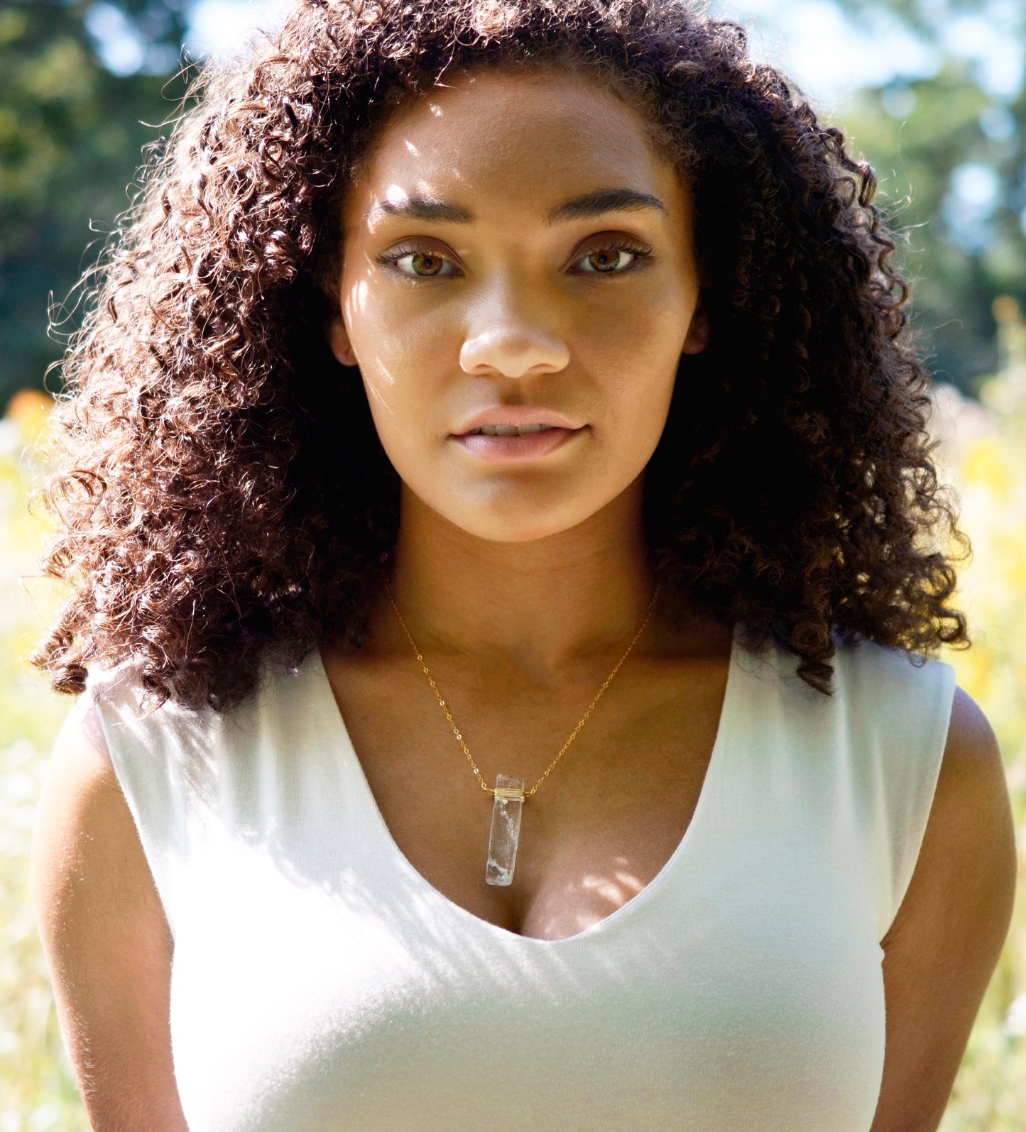 Rectangular shaped natural clear crystal Quartz gemstone set into a 14k gold filled chain. Modeled image.