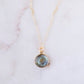 Round natural blue labradorite donut shaped pendant set on a 14k gold filled chain. This necklace is handmade by Gemnia Jewelry in Connecticut.