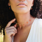 Multiple carnelian teardrop gemstones hang from a 14k gold filled chain. Modeled image. 