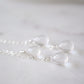 Close up of clear crystal quartz teardrops. Earrings are shown in sterling silver.
