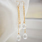 Long clear crystal quartz earrings with two teardrop dangles hanging from a dainty 14k gold filled chain.