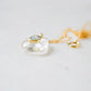 Side view. Handmade Maris necklace featuring a Blue Topaz set inside a clear Rock Crystal frame on a 14K Gold Filled chain. Ideal gift for wife, girlfriend, or mom. Minimalist topaz pendant for layering.
