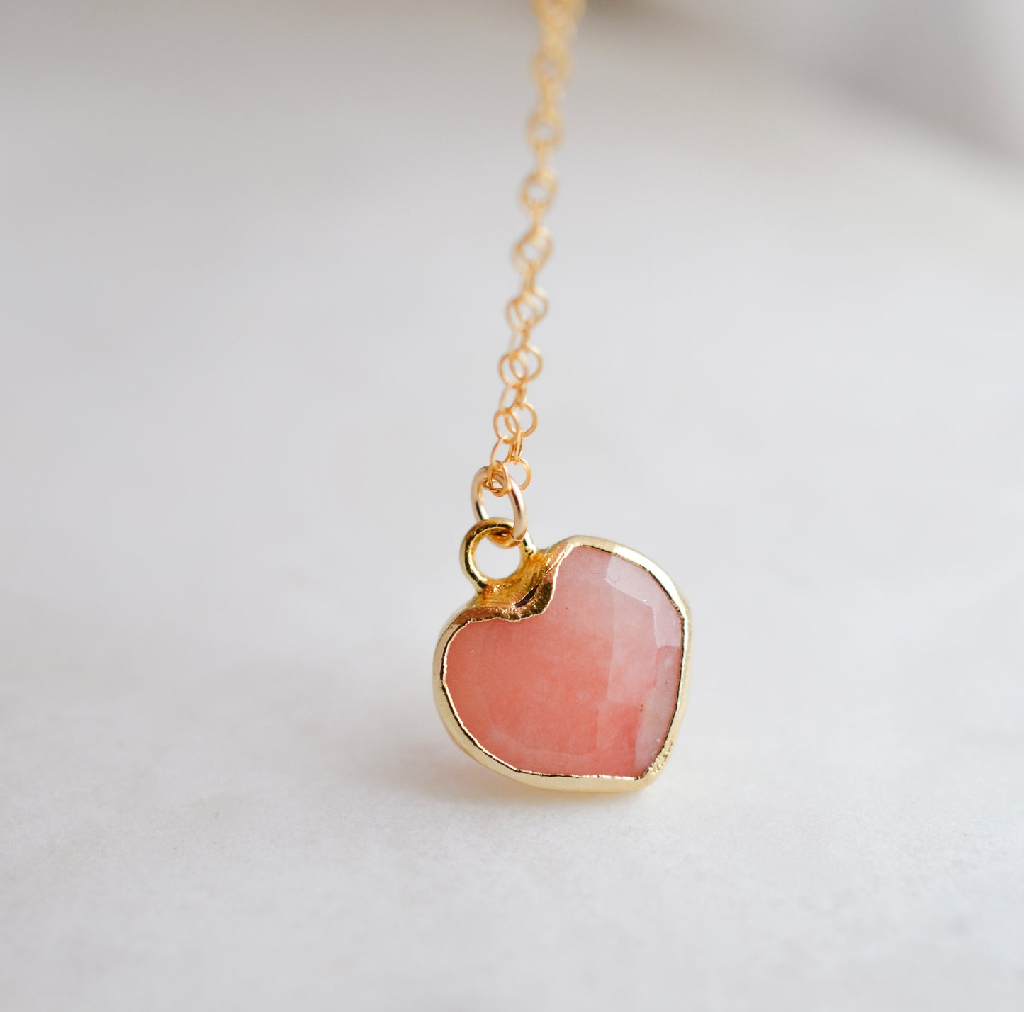 Handmade necklace with a natural pink opal heart-shaped pendant on a 14k gold filled chain. Handcrafted dainty gemstone jewelry by Gemnia.