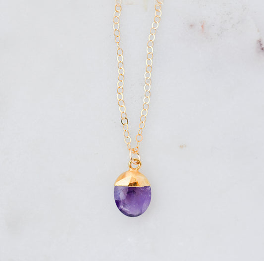 Necklace with a purple amethyst teardrop pendant and 14k gold filled dainty chain. Handmade gemstone jewelry in Connecticut by GEMNIA.