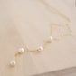 Four semi-round white freshwater pearls are suspended in a Y-style necklace on a 14k gold filled chain. Each pearl is approximately one inch apart. This necklace is also available in sterling silver.