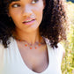 Handmade necklace featuring nine natural Carnelian gemstones set onto a gold filled chain. Sterling Silver is also available. Modeled Image.