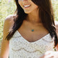 A modeled image of a woman wearing a gold Labradorite necklace. The handmade pendant pendant is bezeled in gold and set on a 14k gold filled chain. This necklace is also available in sterling silver. The stone is oval in shape and flashes blue, green, or yellow.