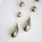 Handcrafted long pyrite crystal earrings. Close up of faceted teardrops.