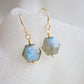 Blue flashing Labradorite gemstones in a faceted hexagonal shape dangle from 14k gold filled earring hooks. Small gold beads accent below the stone. Also available in sterling silver.