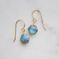 Blue flashing Labradorite gemstones in a faceted hexagonal shape dangle from 14k gold filled earring hooks. Small gold beads accent below the stone. Also available in sterling silver.