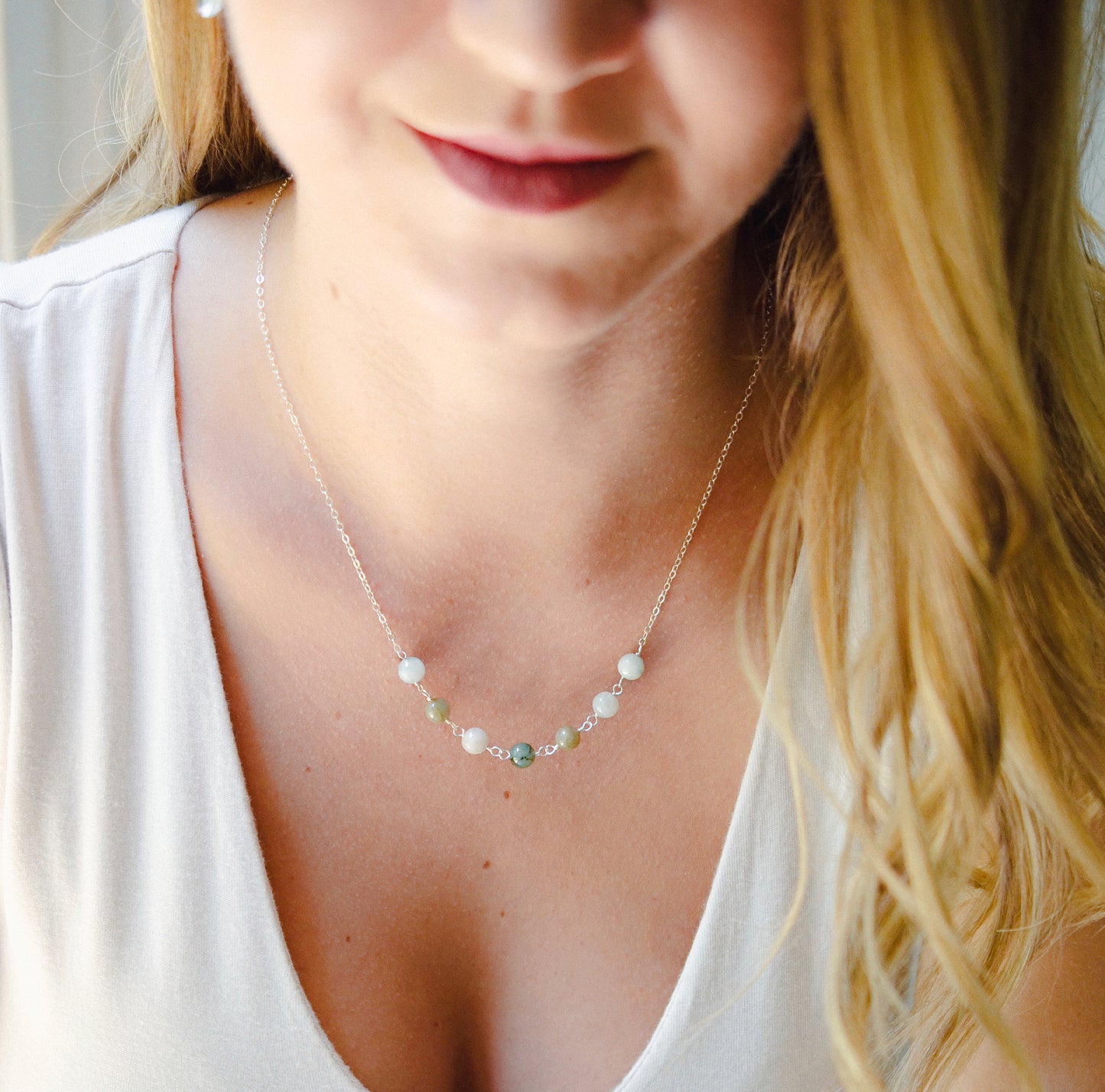 Modeled image. A multi-color burma jade necklace featuring seven round green, brown, yellow, or blue natural stones. Handmade in Connecticut by Gemnia Jewelry.