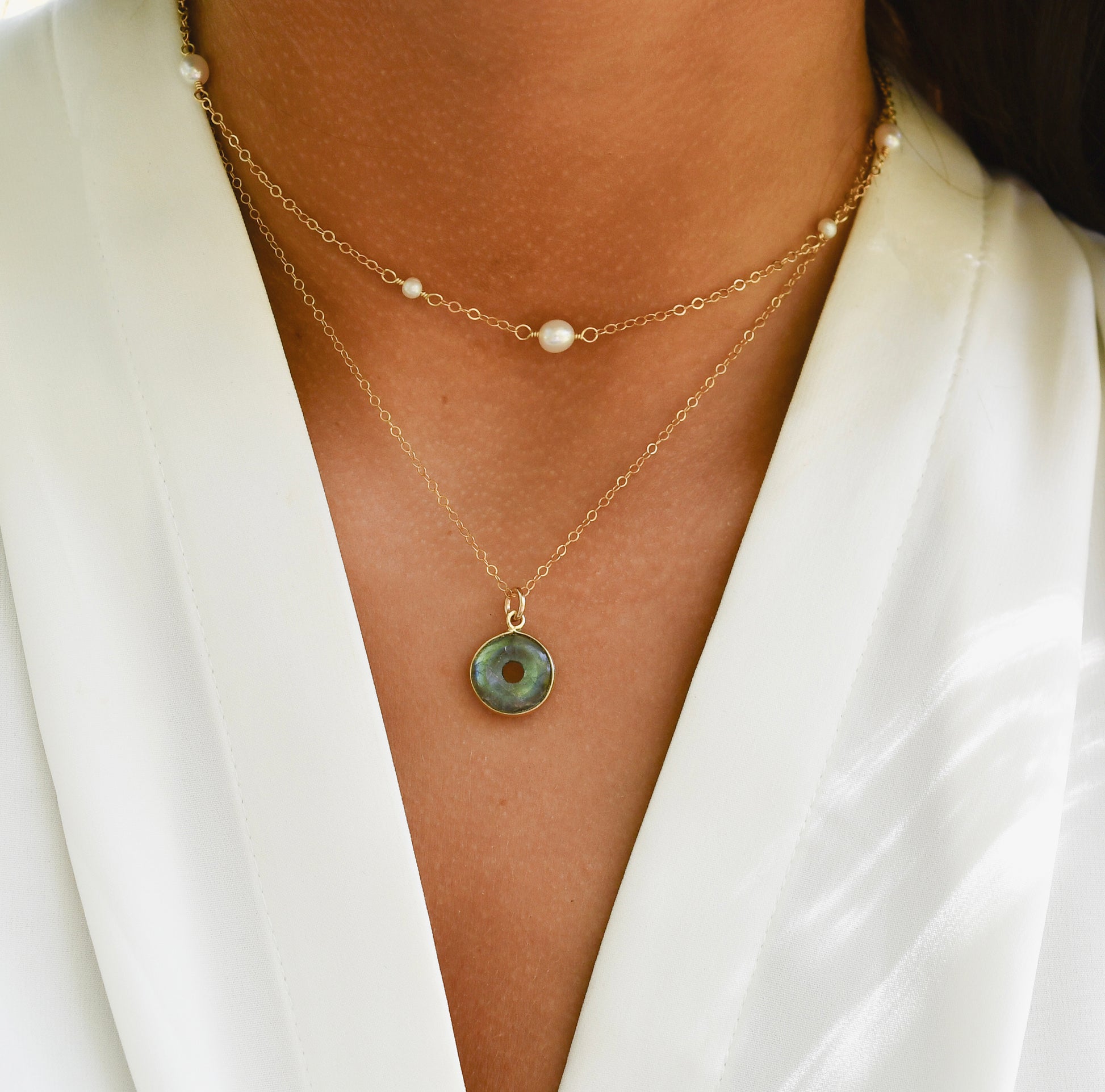 A labradorite pendant layered with a pearl chain necklace in 14k gold filled. Handmade dainty gemstone jewelry.
