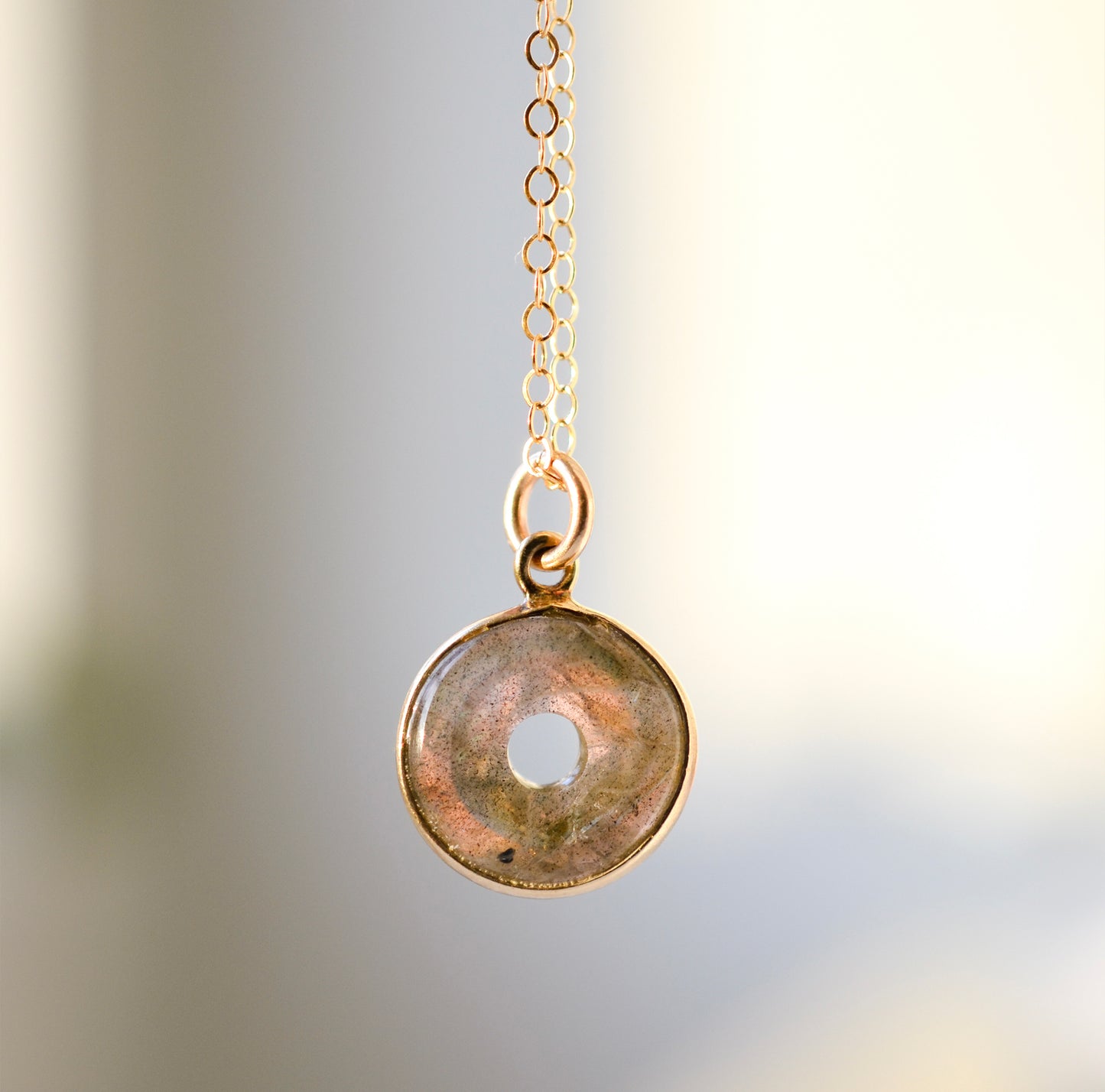 A genuine smooth polished labradorite pendant necklace set on a 14k gold filled cable chain.