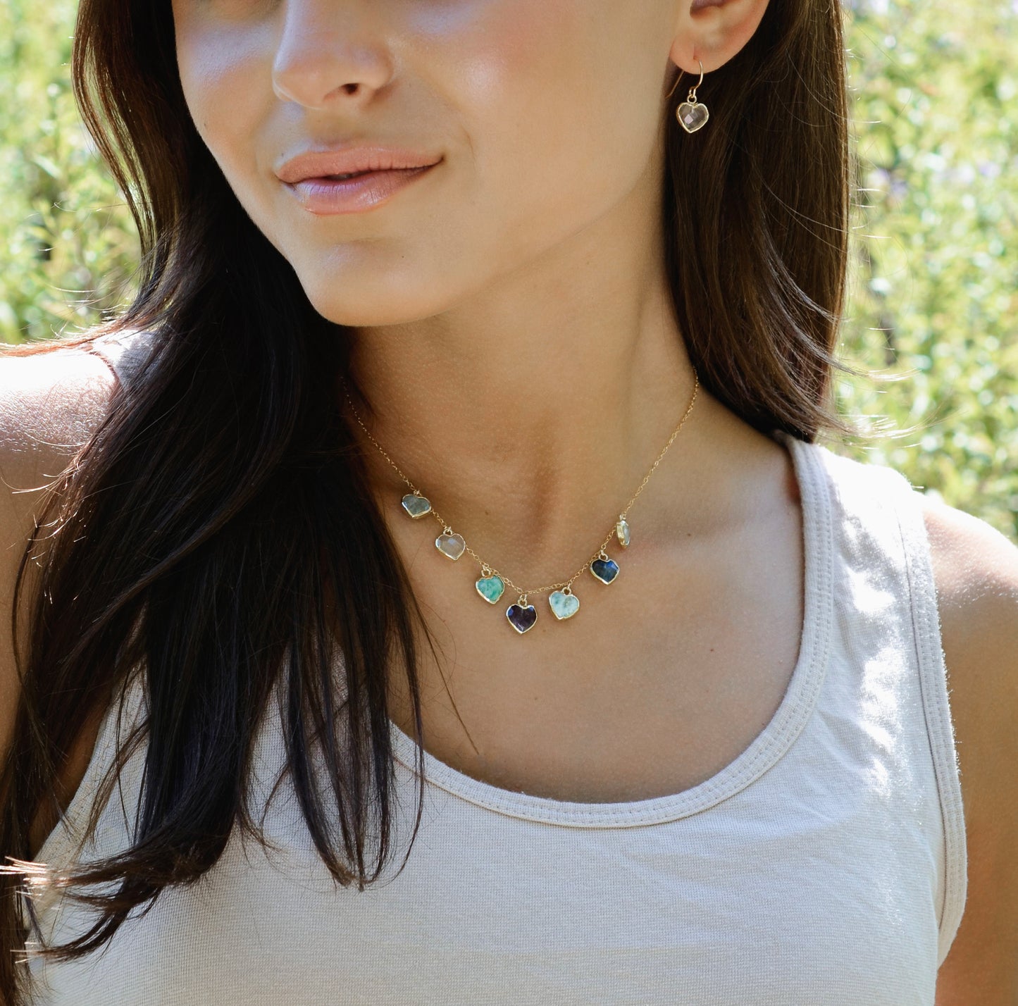 Modeled image: Handmade dainty heart necklace with heart-shaped gemstones on a 14k gold filed chain. Stones include: Aquamarine, Rose Quartz, Amazonite, Larimar, Labradorite, Amethyst, and Rainbow Moonstone