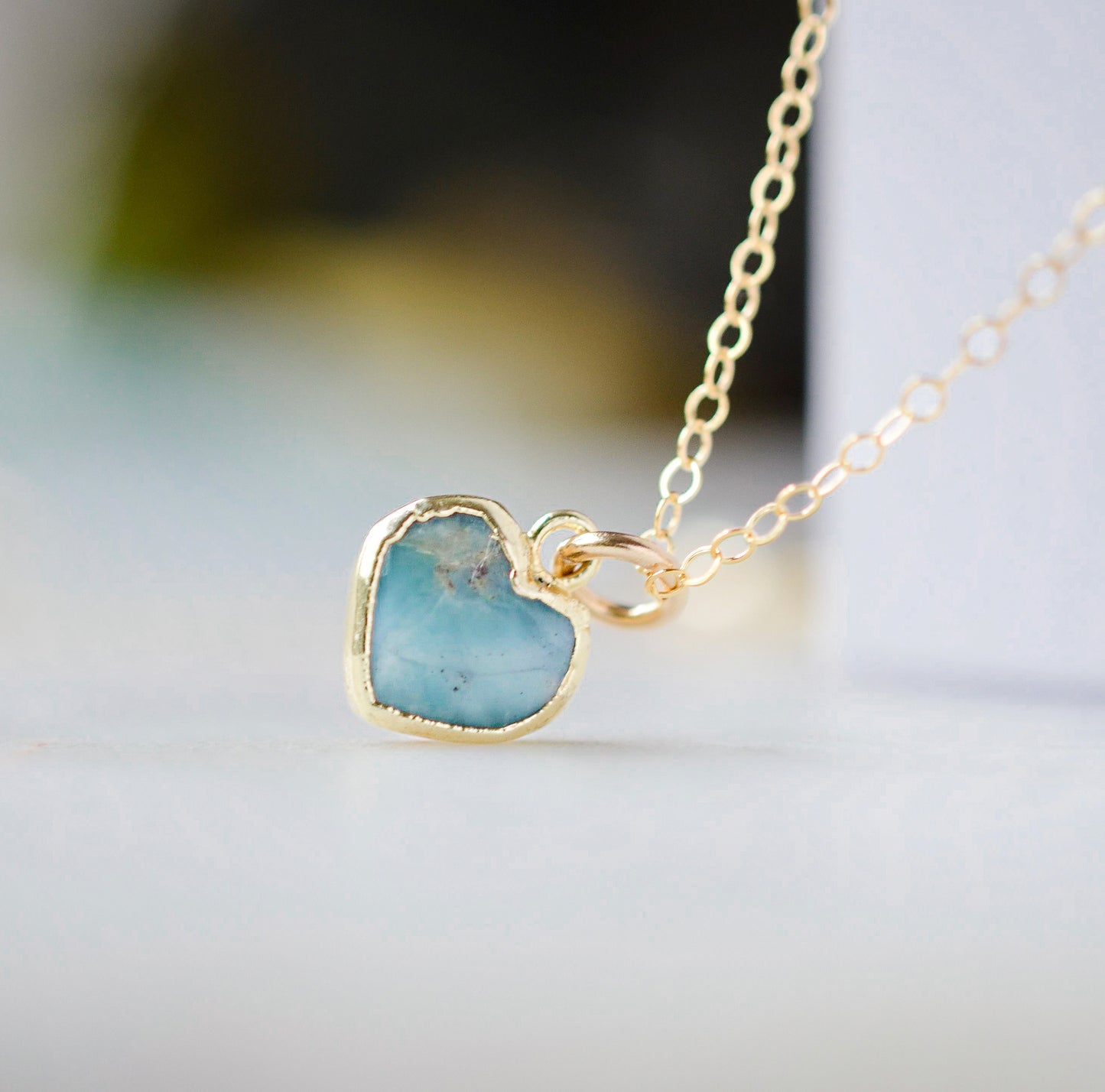 Genuine, real, blue Larimar stone heart necklace. The stone is bezeled in gold and set on a 14k gold filled cable chain. This pendant is a great romantic gift for wife, girlfriend, or valentine's day.
