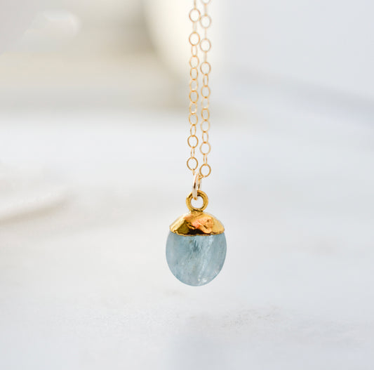 Necklace with a 14k gold filled chain and aquamarine blue pendant. Handmade crystal jewelry in Connecticut. 