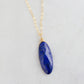 A handmade natural blue lapis lazuli stone pendant on a delicate minimalist 14k gold filled chain. This necklace is made in Connecticut by Gemnia Jewelry.