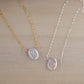 Single white oval shaped freshwater pearl suspended from a sterling silver or 14k gold filled cable chain.