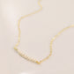 White freshwater pearl bar necklace shown in 14k gold filled. The peals are small and slightly irregular in shape.