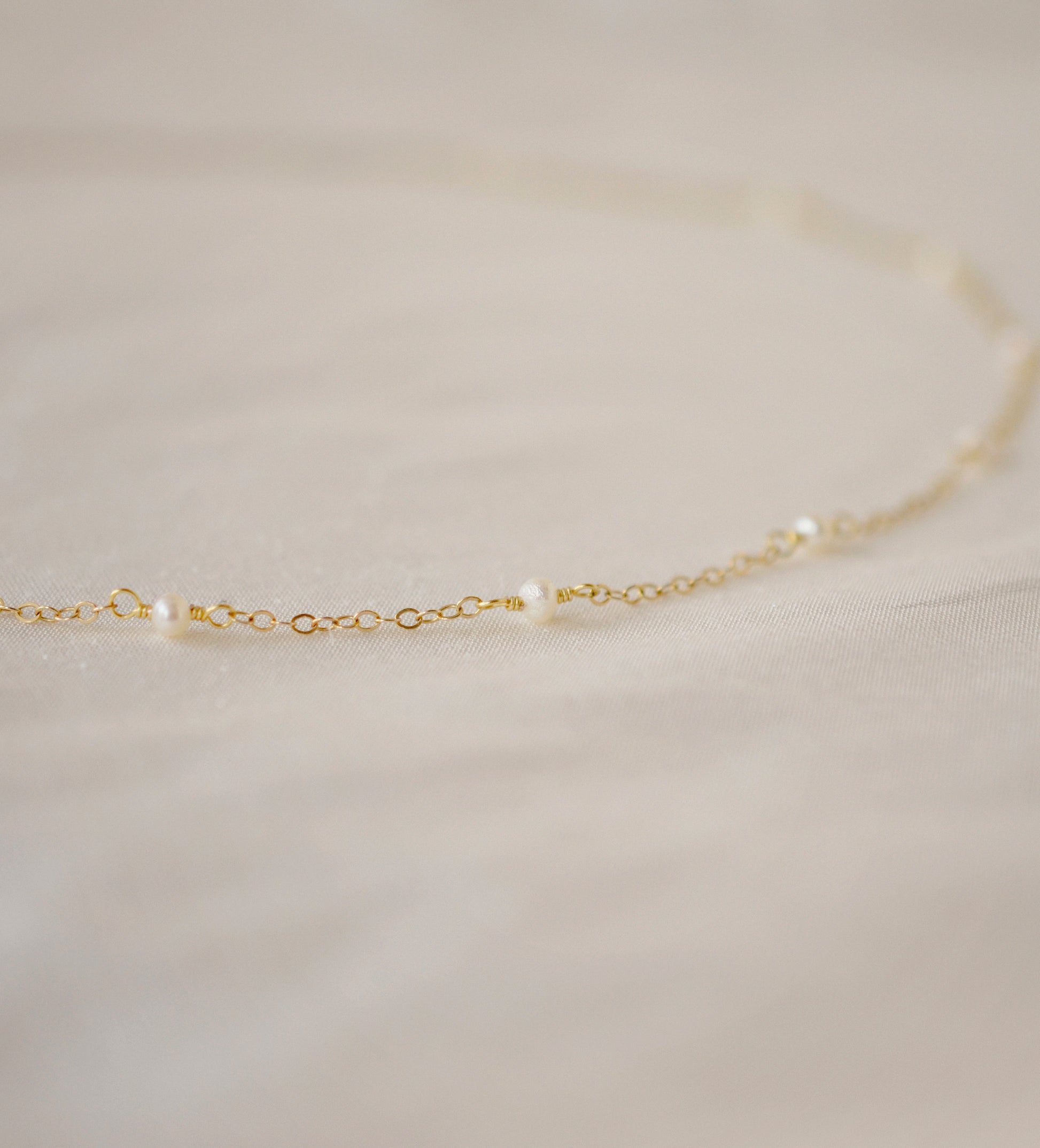 Genuine white freshwater pearls set onto a 14k gold filled chain. 