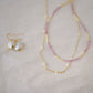 Genuine white freshwater pearls set onto a 14k gold filled chain. Shown with matching pearl earrings and a pick tourmaline necklace.