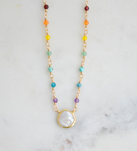 Rainbow, pride, or chakra necklace with tiny gemstones and a white freshwater pearl. The 14k gold filled style is shown.