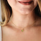 Natural green Peridot faceted teardrop suspended from a 14k gold filled cable chain. Modeled image.