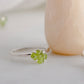 Raw green peridot ring on a sterling silver band. Close up image.