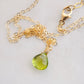 Natural green Peridot faceted teardrop suspended from a 14k gold filled cable chain.