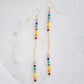 Two long, straight bars of crystals arranged in a rainbow pattern separated by a dainty chain. The gold style is shown showing the flexible chain.