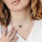 Modeled image of a raw black sunstone gemstone set on a sterling silver chain.