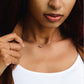 Small, dainty raw pink Tourmaline crystal set on a sterling silver chain. Modeled image.